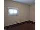 Neutral bedroom features hardwood floors, neutral walls, and one window providing natural light at 1033 Cottage Ave, Columbus, IN 47201