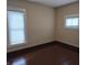 Bedroom with hardwood floors, neutral walls, and two windows providing natural light at 1033 Cottage Ave, Columbus, IN 47201