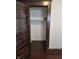 View of an empty closet with built-in shelving and hardwood flooring at 1033 Cottage Ave, Columbus, IN 47201