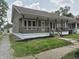 Charming single-story home featuring a cozy front porch with wood railings and a well-maintained lawn at 1033 Cottage Ave, Columbus, IN 47201