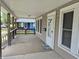 Covered front porch featuring wood railings, a white door with glass, and space for seating at 1033 Cottage Ave, Columbus, IN 47201