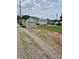 View of detached garage with gravel driveway and yard at 1033 Cottage Ave, Columbus, IN 47201