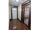 Hallway shows wood floors and trim along with white front door at 1033 Cottage Ave, Columbus, IN 47201