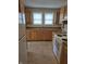 A kitchen featuring wood cabinets, laminate countertops, and dual windows at 1033 Cottage Ave, Columbus, IN 47201