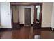 Living room featuring original, dark wood trim and access to additional rooms at 1033 Cottage Ave, Columbus, IN 47201
