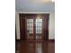 Spacious living room with hardwood floors and paneled french doors at 1033 Cottage Ave, Columbus, IN 47201