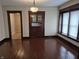 Bright living room featuring beautiful hardwood floors and a built-in display cabinet at 1033 Cottage Ave, Columbus, IN 47201
