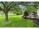 Lush backyard featuring mature trees and a wooden deck, perfect for outdoor relaxation at 10410 Trillium Ct, Noblesville, IN 46060