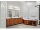 A bright bathroom with double vanity, tile floor, jacuzzi and a glass shower at 10410 Trillium Ct, Noblesville, IN 46060
