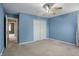 The bedroom features carpet flooring, blue walls, and a closet with doors at 10410 Trillium Ct, Noblesville, IN 46060