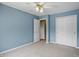 A bedroom with blue walls, neutral carpet and closet storage at 10410 Trillium Ct, Noblesville, IN 46060