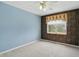 A bedroom with blue walls, patterned wallpaper and neutral carpet, highlighted by natural light at 10410 Trillium Ct, Noblesville, IN 46060