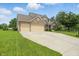 Lovely two-story home with a three-car garage and large front lawn and mature trees at 10410 Trillium Ct, Noblesville, IN 46060