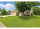 Well-maintained front lawn and landscaping surround a two-story brick home with a three-car garage at 10410 Trillium Ct, Noblesville, IN 46060