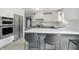 This modern kitchen features stainless steel appliances, quartz countertops, and bar seating at 10410 Trillium Ct, Noblesville, IN 46060