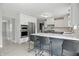 This modern kitchen features stainless steel appliances, quartz countertops, and bar seating at 10410 Trillium Ct, Noblesville, IN 46060