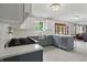 This modern kitchen features stainless steel appliances, gray cabinets, quartz countertops, and an island at 10410 Trillium Ct, Noblesville, IN 46060
