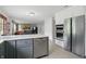 This modern kitchen features stainless steel appliances, an island with gray cabinets and quartz countertops at 10410 Trillium Ct, Noblesville, IN 46060