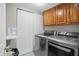 Laundry room featuring modern washer and dryer sets and storage cabinets at 10410 Trillium Ct, Noblesville, IN 46060