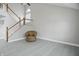 Entry featuring a staircase and chair, complemented by wood-look flooring and ample natural light at 10410 Trillium Ct, Noblesville, IN 46060