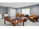 A well-lit living room featuring modern light gray walls, white cabinets, and comfortable brown leather furniture at 10410 Trillium Ct, Noblesville, IN 46060