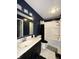 Full bathroom features a tub, shower, vanity, sink, and toilet for all your needs with contrasting blue and white at 10832 Tealpoint Dr, Indianapolis, IN 46229