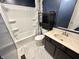 Cozy bathroom with tub, commode, vanity, decorative shelving, and marbled shower curtain at 10832 Tealpoint Dr, Indianapolis, IN 46229