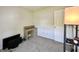 Bedroom with neutral carpet, a desk, a door, and a standing lamp at 10832 Tealpoint Dr, Indianapolis, IN 46229
