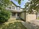 Charming two-story home featuring blue shutters and an attached two car garage at 10832 Tealpoint Dr, Indianapolis, IN 46229