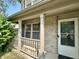 A cozy front porch area with white railing and brick accents on a home's exterior at 10832 Tealpoint Dr, Indianapolis, IN 46229