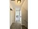 Hallway featuring neutral colored walls and carpet with multiple white doors at 10832 Tealpoint Dr, Indianapolis, IN 46229