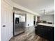 Kitchen featuring stainless steel refrigerator and contrasting black cabinets at 10832 Tealpoint Dr, Indianapolis, IN 46229