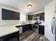Kitchen showcasing stainless steel appliances, black cabinets, and bright counter tops at 10832 Tealpoint Dr, Indianapolis, IN 46229