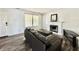 An open-concept living room features modern dark floors, fireplace, and a comfortable brown couch at 10832 Tealpoint Dr, Indianapolis, IN 46229