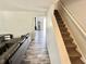 Bright hallway with view to the living room, featuring modern flooring and a staircase to the second floor at 10832 Tealpoint Dr, Indianapolis, IN 46229