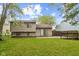 A spacious backyard with a concrete patio and a well-maintained lawn and mature trees at 11114 Wismar Dr, Indianapolis, IN 46235