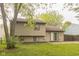 View of the home from the yard featuring a large tree at 11114 Wismar Dr, Indianapolis, IN 46235