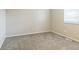 A simple carpeted bedroom with a window and electrical outlets at 11114 Wismar Dr, Indianapolis, IN 46235