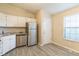A well-lit kitchen with stainless steel appliances, granite countertops, and modern gray flooring at 11114 Wismar Dr, Indianapolis, IN 46235