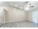 Bright living room with vaulted ceiling, ceiling fan, and modern gray vinyl plank flooring at 11114 Wismar Dr, Indianapolis, IN 46235