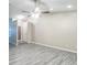 Open living room with modern gray vinyl plank flooring, ceiling fan, and neutral walls at 11114 Wismar Dr, Indianapolis, IN 46235
