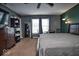 Comfortable carpeted bedroom featuring natural light, ceiling fan, and warm ambient lighting at 11303 Cuyahoga Dr, Indianapolis, IN 46235