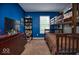 Blue bedroom featuring a bunk bed, dresser with a TV, and a window at 11303 Cuyahoga Dr, Indianapolis, IN 46235
