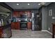 Well-lit kitchen boasts stainless steel appliances, dark cabinetry, and modern flooring at 11303 Cuyahoga Dr, Indianapolis, IN 46235