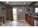 Bright kitchen featuring modern countertops, wood cabinets, and a door to the backyard at 11303 Cuyahoga Dr, Indianapolis, IN 46235