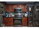 Cozy kitchen features stainless steel appliances, dark cabinetry, and stylish backsplash at 11303 Cuyahoga Dr, Indianapolis, IN 46235