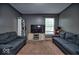 Relaxing living room featuring comfortable sofas, a window with natural light, and carpeting at 11303 Cuyahoga Dr, Indianapolis, IN 46235