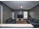 Cozy living room featuring comfortable sofas, a window with natural light, and carpeting at 11303 Cuyahoga Dr, Indianapolis, IN 46235