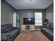 Comfortable living room features neutral walls, carpeting, and a window with natural light at 11303 Cuyahoga Dr, Indianapolis, IN 46235