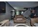 Comfortable living room with a large recliner, gray walls, and a view of the staircase at 11303 Cuyahoga Dr, Indianapolis, IN 46235
